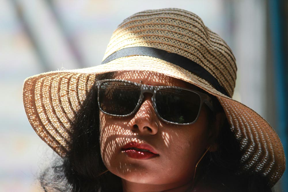 Woman wearing sunglasses and a hat