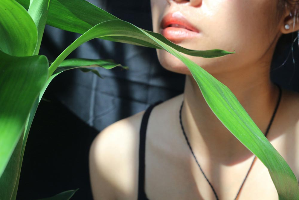 Woman behind a plant
